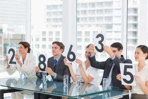 Group of panel judges holding score signs